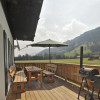 Schöne Holzterrasse mit Griller und Garten rund herum