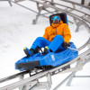 The 4,800-foot-long alpine mountain coaster Beast Mountain Coaster twists and turns through the woods.