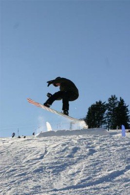 Snowboarders enjoy the integrated fun park in the skiing area