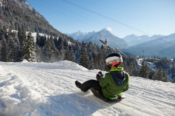 Auf der Naturrodelbahn kannst du ins Tal flitzen.